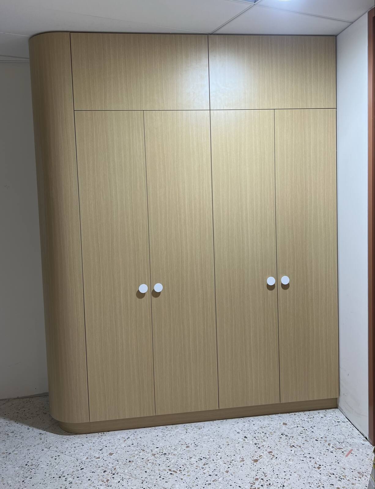 Curved timber wardrobe joinery with integrated handles